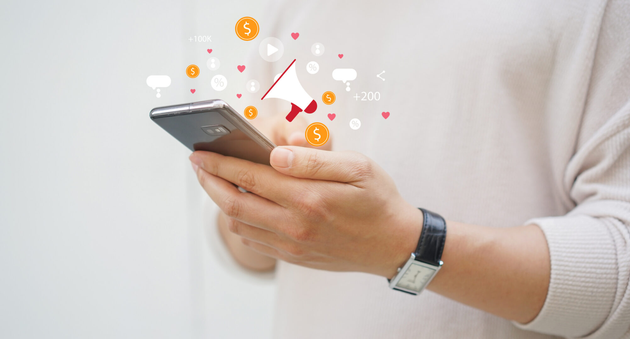 Hands holding smartphone with marketing icons